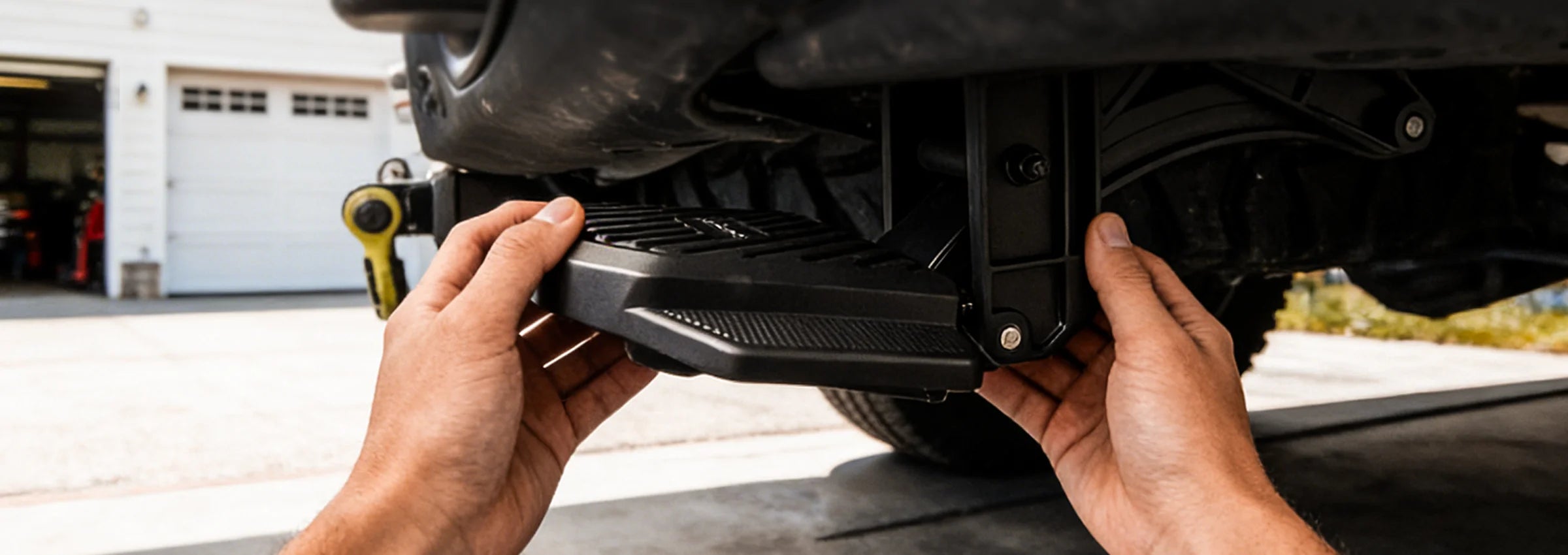 Simple no-drill bolt-on installation of a WOLFBOX retractable step on a truck chassis.