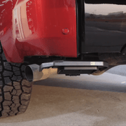 Operating the Wolfbox Retractable Truck Bed Step: Hands-free foot deployment and easy stow-away under the rear bumper.