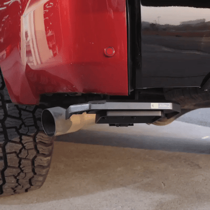 Operating the Wolfbox Retractable Truck Bed Step: Hands-free foot deployment and easy stow-away under the rear bumper.