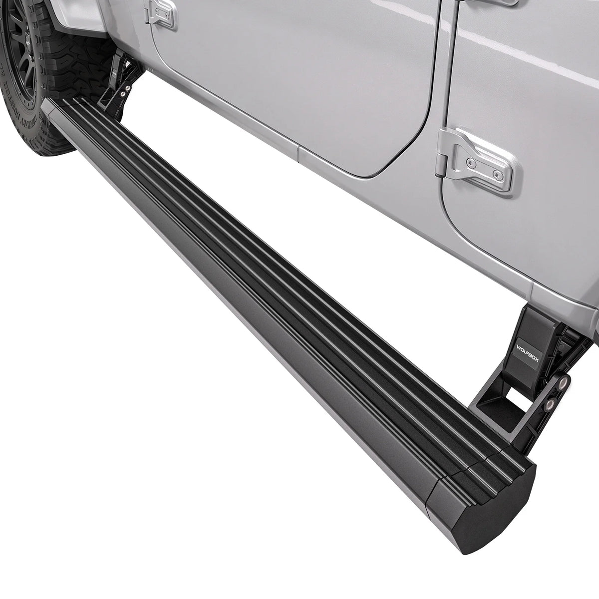 Black electric running board fully deployed on a silver Jeep, showing the low step position for easy cabin entry and exit on SUVs and pickup trucks.