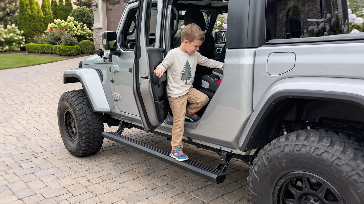 Young child climbing into a Jeep using a Wolfbox power running board, demonstrating that the low step height is safe and accessible for kids and shorter passengers.