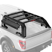 Effortless strut-assisted side access to the truck bed through flip-up tactical MOLLE panels