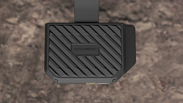 Close-up of a wide, textured non-slip step pad on a retractable rear bumper step for enhanced traction.