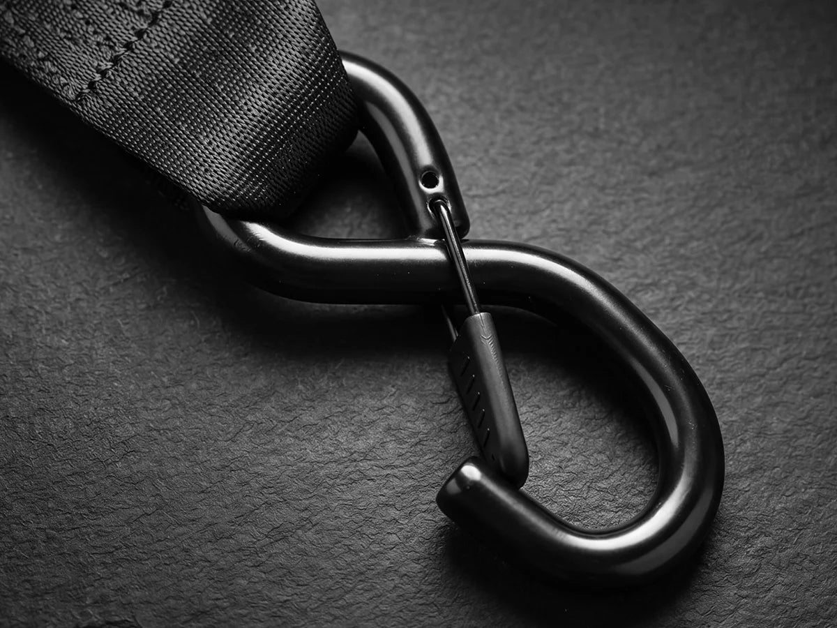 Upgraded fully rubber-coated S-hook on a retractable ratchet strap, protecting paint and gear from scratches while giving a secure grip.