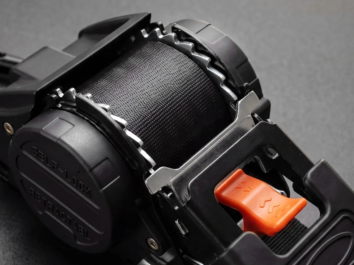 Zinc-plated corrosion-resistant ratchet mechanism with a quick-release button on a retractable ratchet strap, built to resist rust in wet conditions.